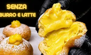 Bomboloni alla crema, soffici e ripieni, senza burro e latte. Un'esplosione di dolcezza.