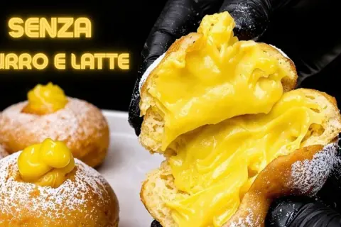 Bomboloni alla crema, soffici e ripieni, senza burro e latte. Un'esplosione di dolcezza.