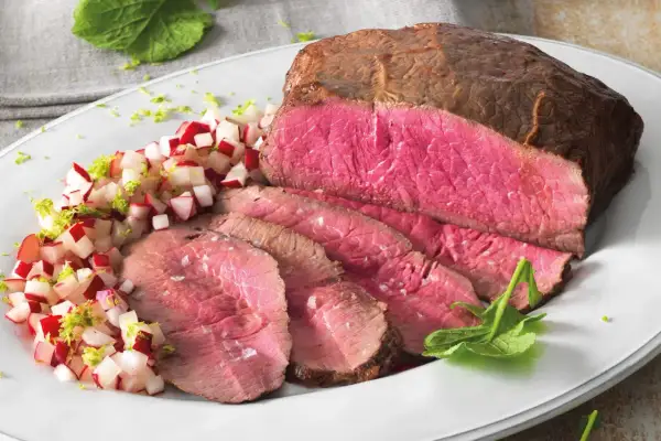 Roast beef ricetta: succulento arrosto affettato con contorno di ravanelli e scorza di lime.