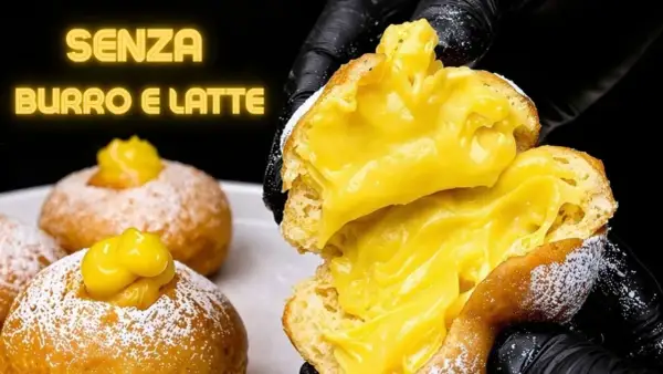 Bomboloni alla crema, soffici e ripieni, senza burro e latte. Un'esplosione di dolcezza.